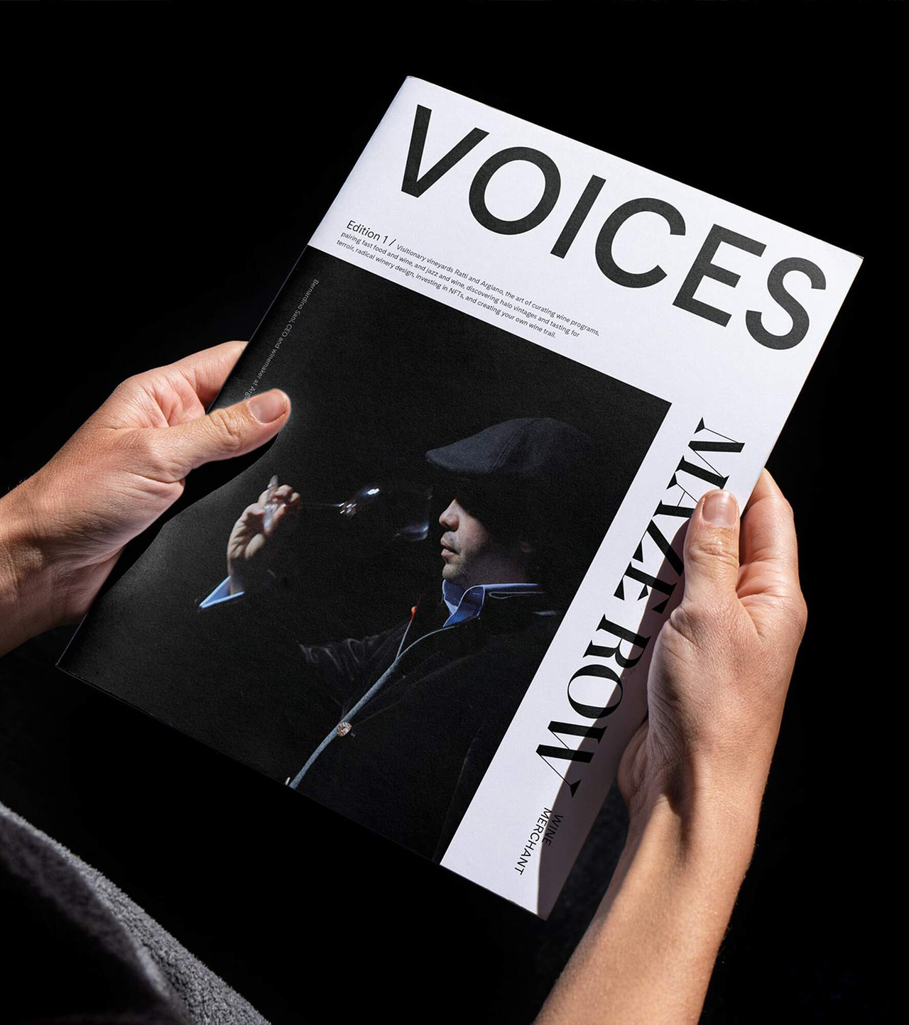 Person holding a copy of Voices magazine.