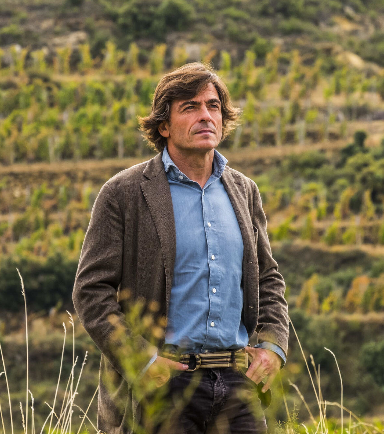 Winemaker for Bodega Lanzaga standing in a vineyard. 