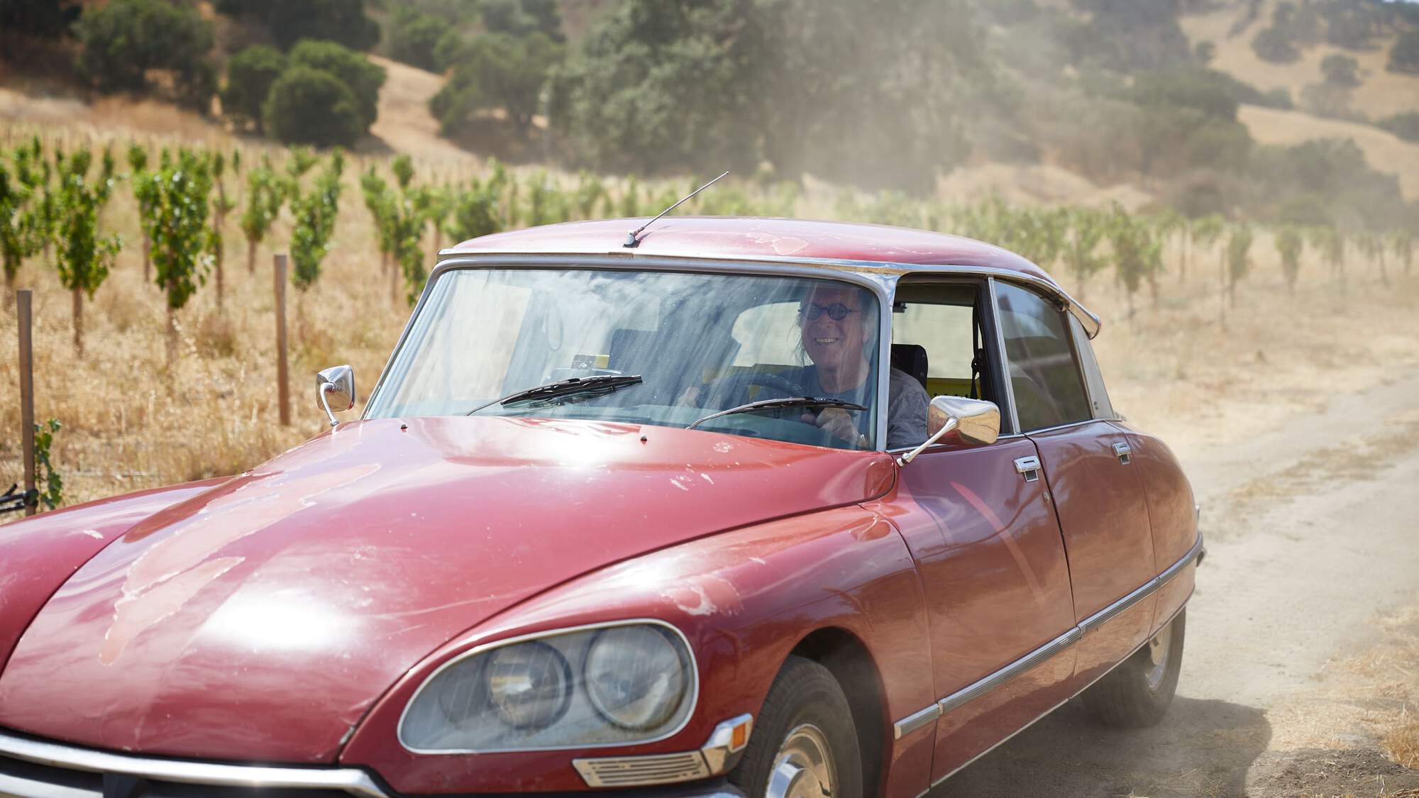 Maze Row producer Randall Grahm driving through his vineyard.