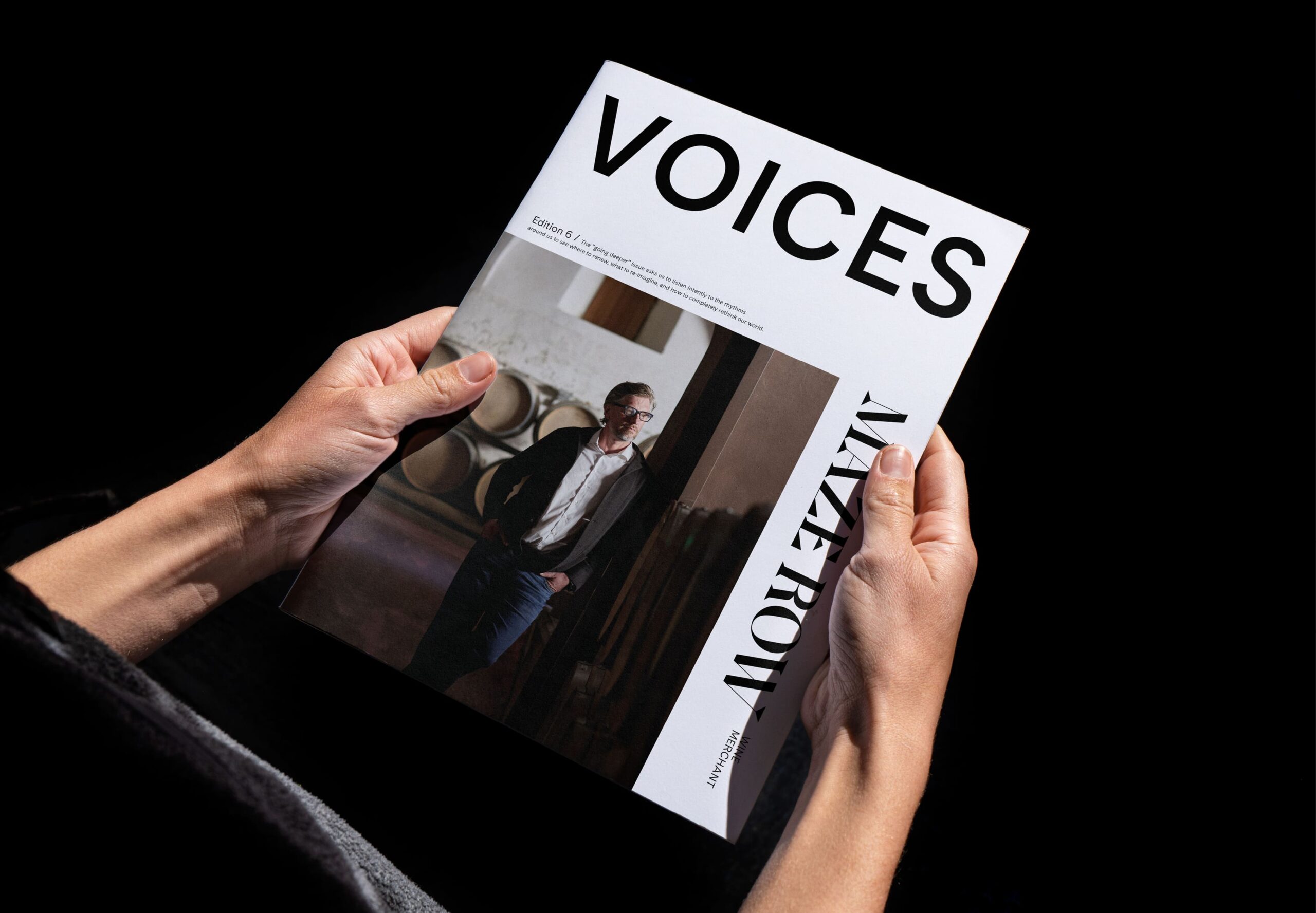 Person holding a copy of Voices magazine.