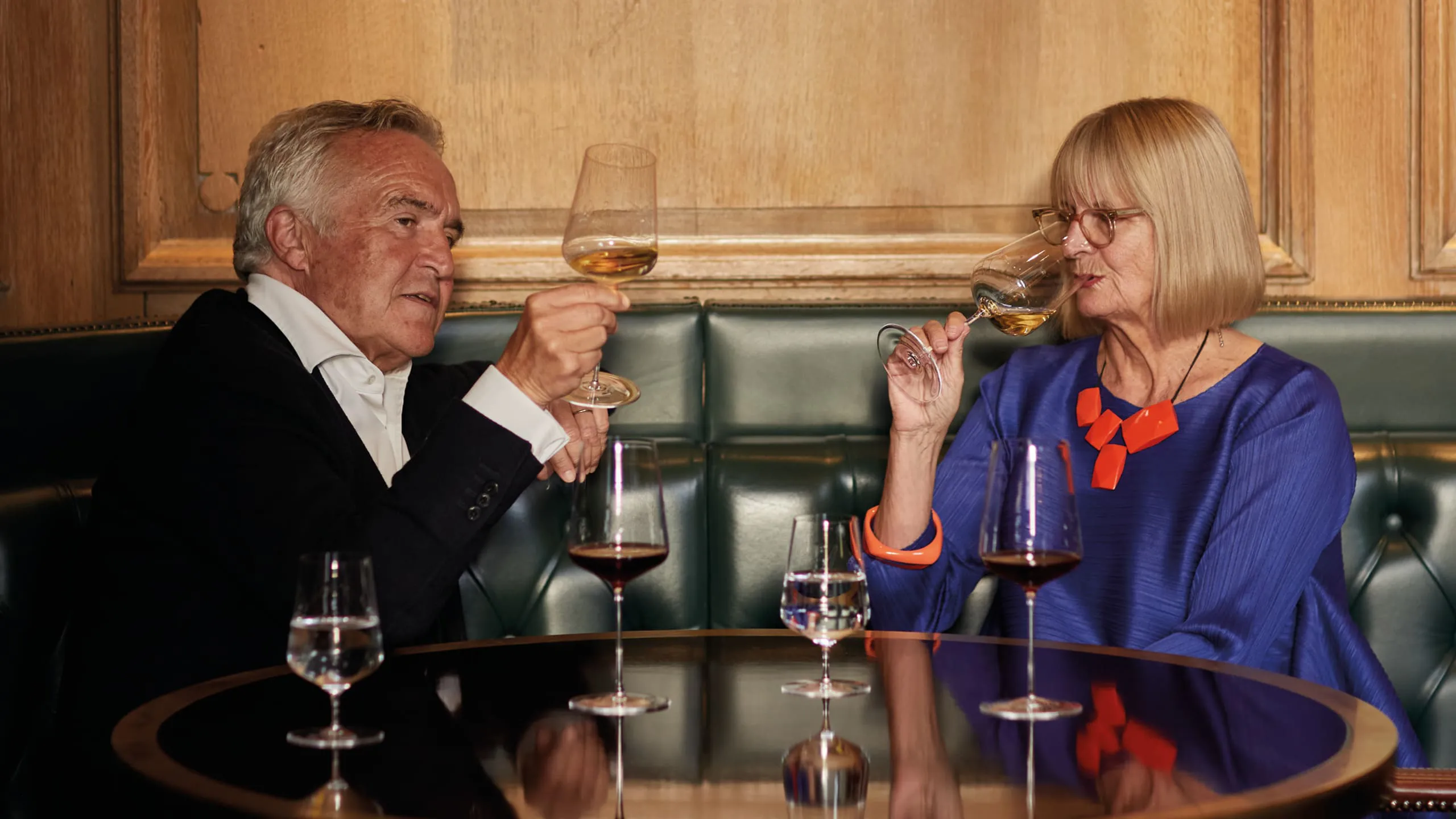 Two people enjoying wine at a table