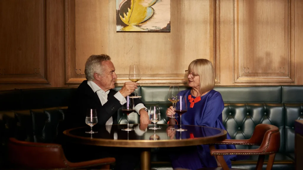 Two people enjoying wine at a table