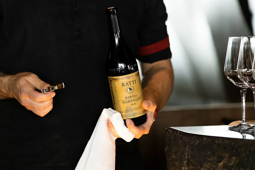 Person holding a wine bottle